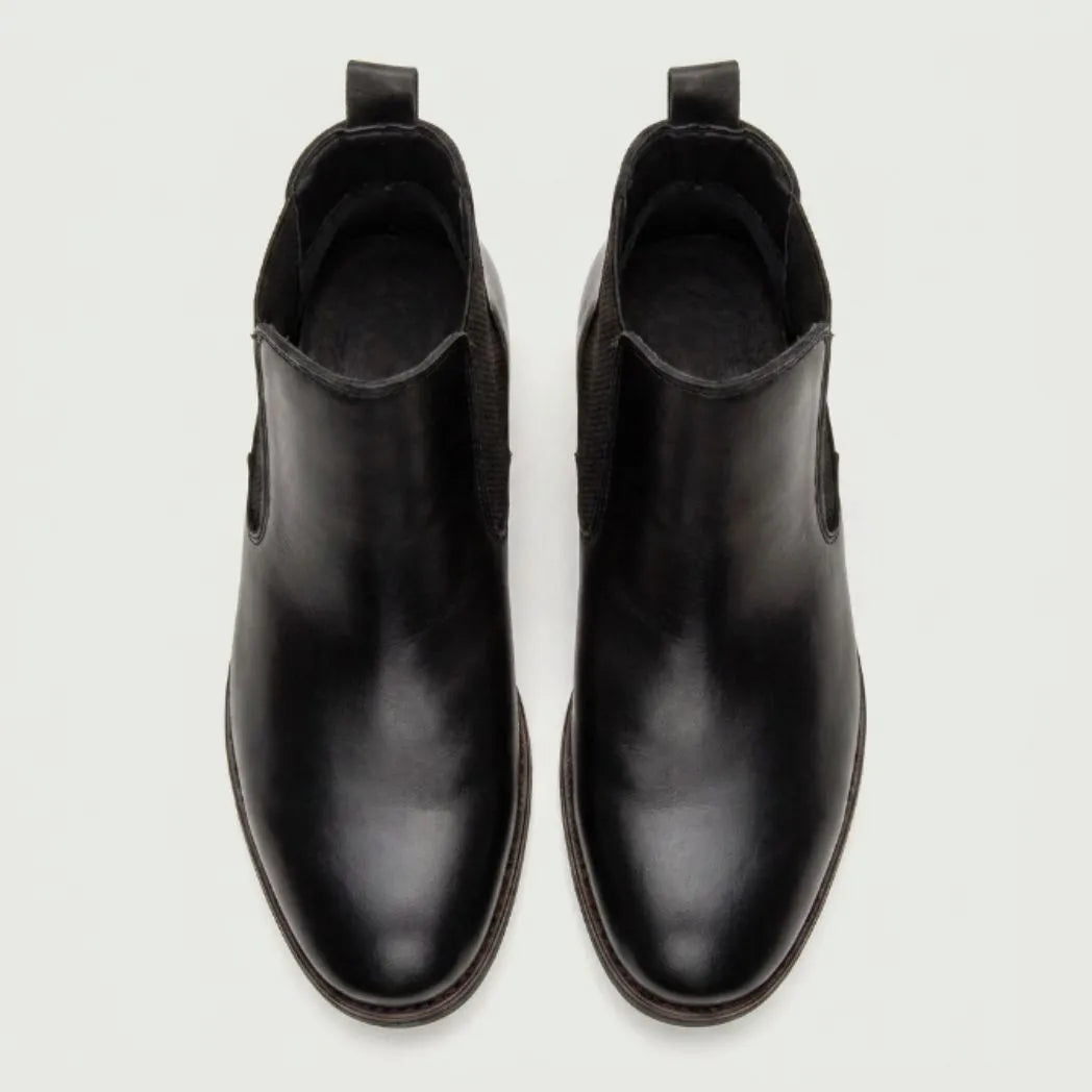 Par de botas Chelsea Londres pretas visto de cima.