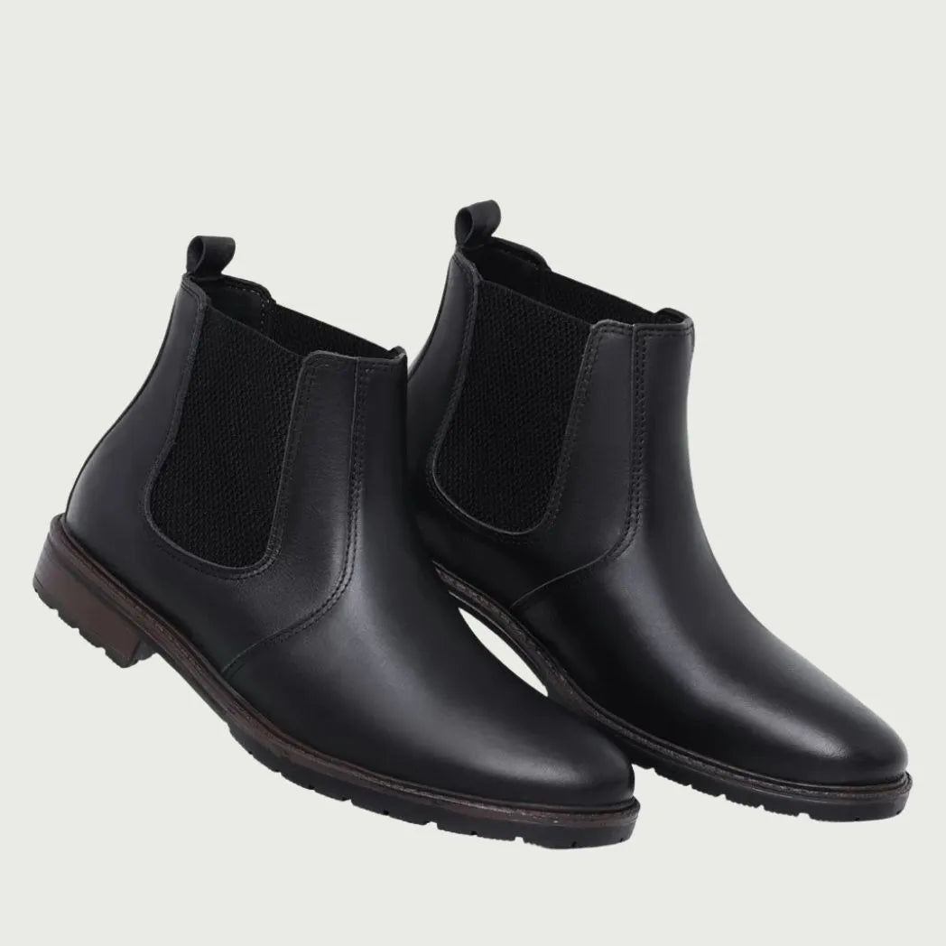 Par de botas Chelsea Sítio pretas em perspectiva, com elásticos laterais visíveis.
