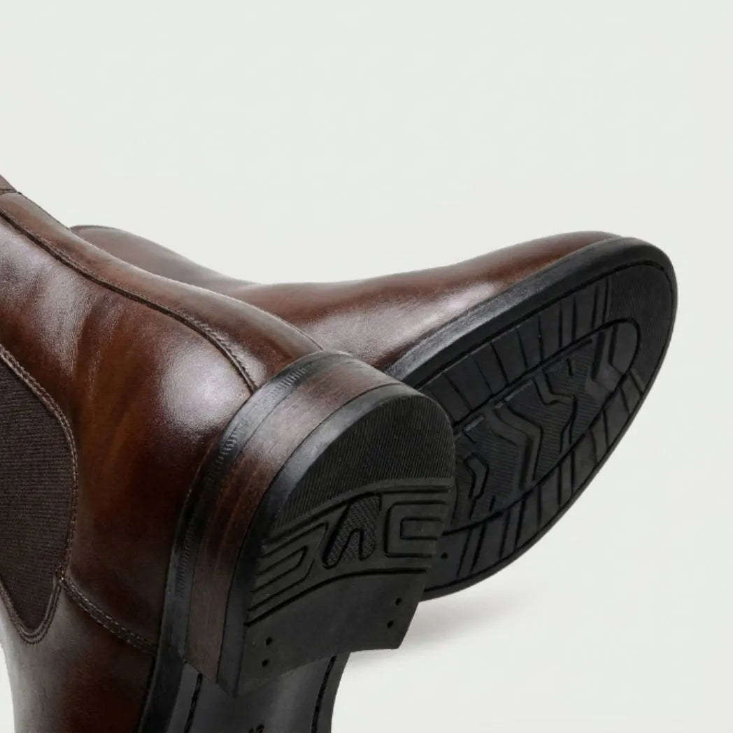 Detalhe do solado e do salto da Bota Chelsea Masculina Nobre marrom.