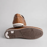Par do modelo Mocassim Casual Canvas em Lona, na cor marrom, com um dos solados voltado para a câmera.