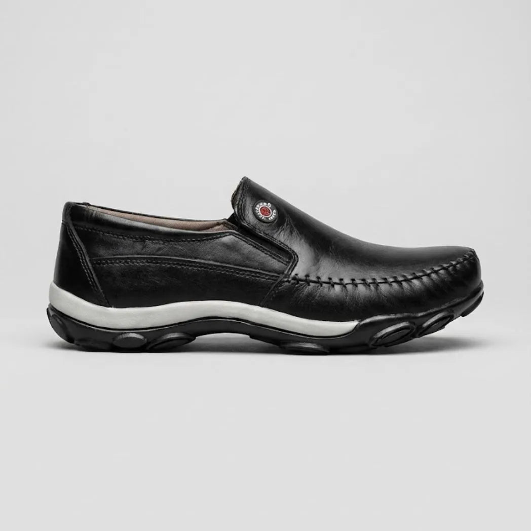 Mocassim Casual Comfort Daytona Drive: modelo preto de perfil, com emblema circular lateral e sola preta e branca.