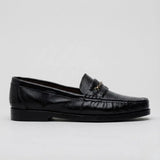Mocassim Casual Loafer Nero: modelo preto de perfil, com pequena ferragem frontal, costura aparente e sola preta.