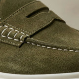 Mocassim Derby de Camurça: detalhe da textura verde-oliva, da faixa frontal e da costura clara.