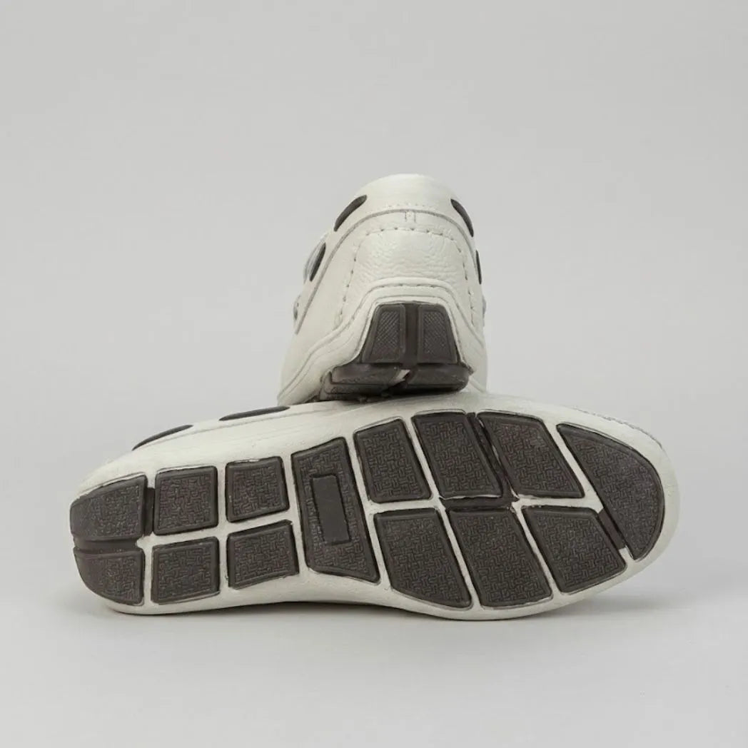 Par do modelo Mocassim Driver Cruise de Couro, na cor branco, com um dos solados voltado para a câmera.