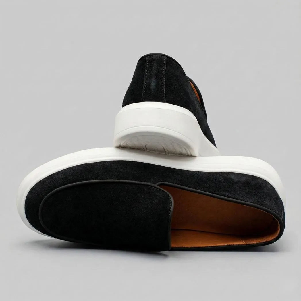 Mocassim Loafer de Camurça Vanguard: par preto em posições opostas, mostrando a abertura e a parte traseira dos sapatos.