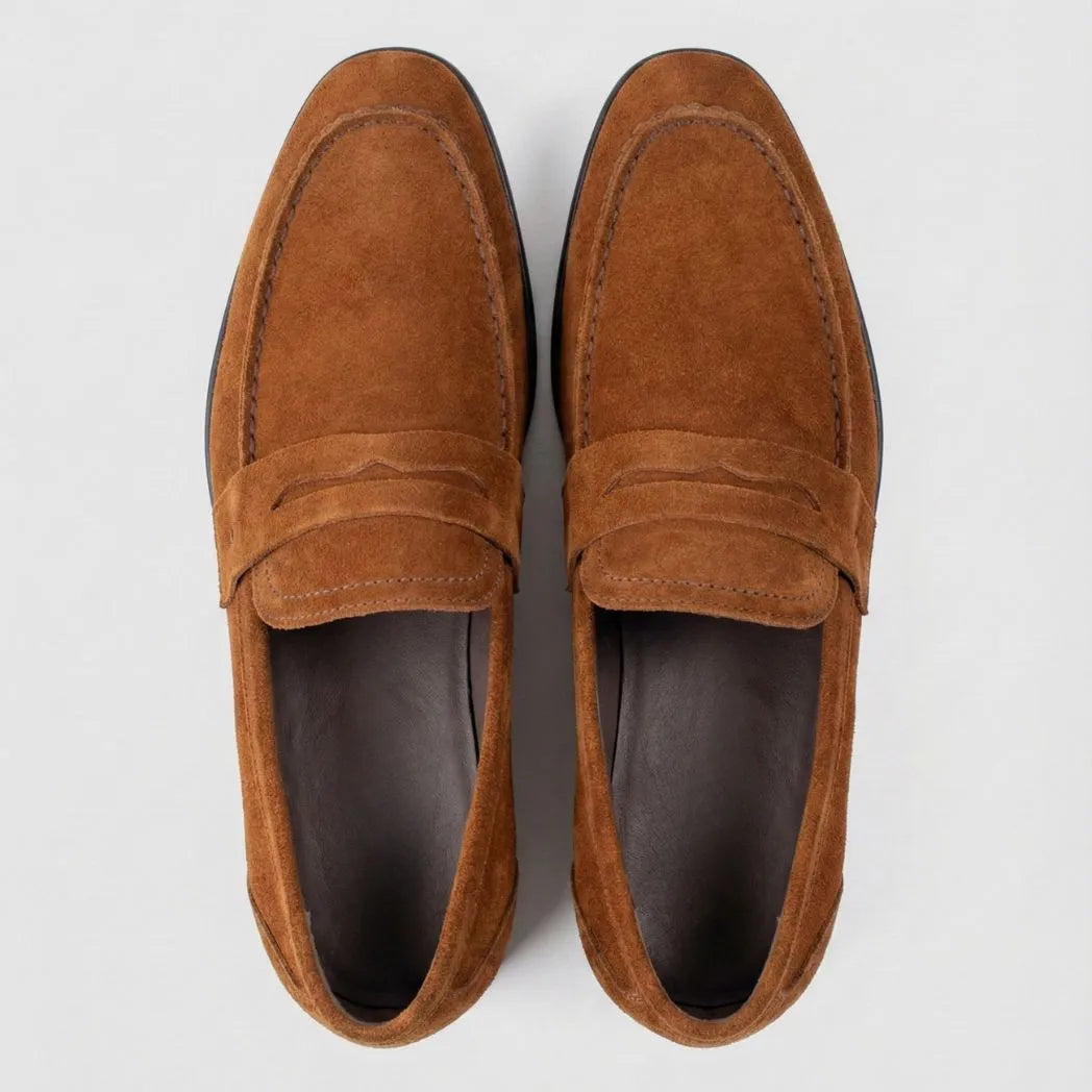 Mocassim Penny Loafer Milano Cognac: par marrom visto de cima, mostrando faixa frontal e interior escuro.