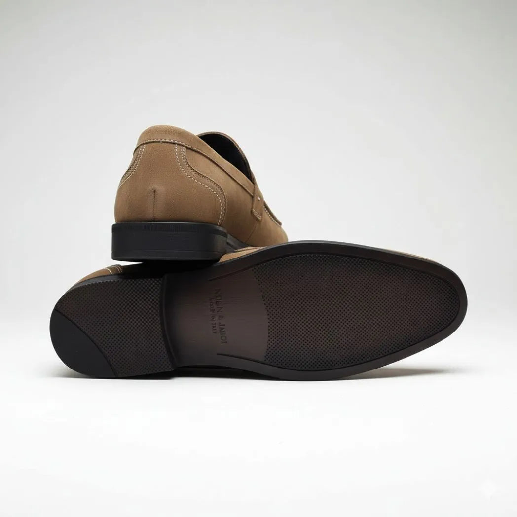 Mocassim Penny Loafer Milano Cognac: par marrom-claro com um sapato virado, mostrando a sola escura.