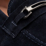 Detalhe da fivela metálica, da textura e das costuras do Mocassim Suede Tratorado de Camurça na cor azul-escuro.