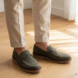 Mocassim Suede Tratorado de Camurça na cor verde, usado com calça clara de barra dobrada.