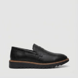 Mocassim Tratorado Torino Ripple: modelo preto de perfil, com faixa frontal, borda marrom e sola preta com sulcos.