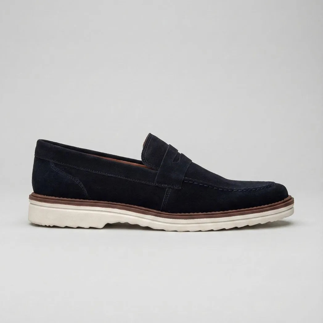 Mocassim de Camurça Monaco Edition: modelo azul-escuro de perfil, com faixa frontal, sola clara e borda marrom.